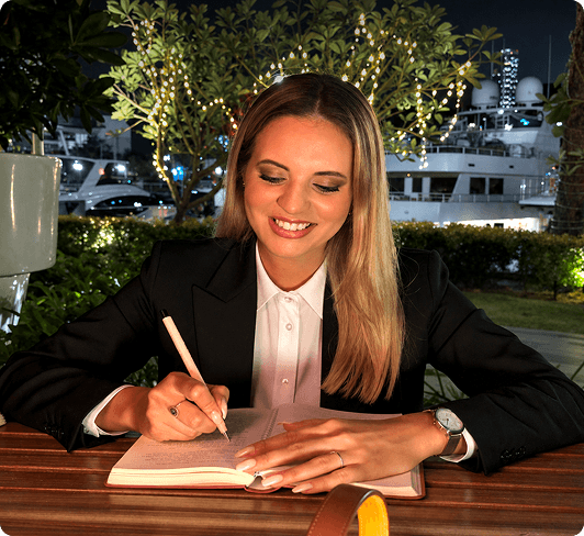 Professional woman writing in a notebook outdoors