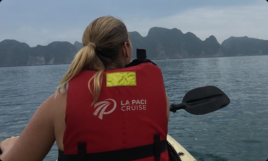 Suzanne Lilley kayaking across calm water after retrenchment